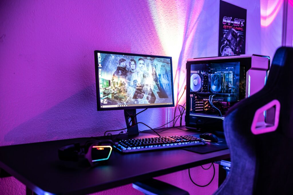 a desk with a computer and a gaming chair